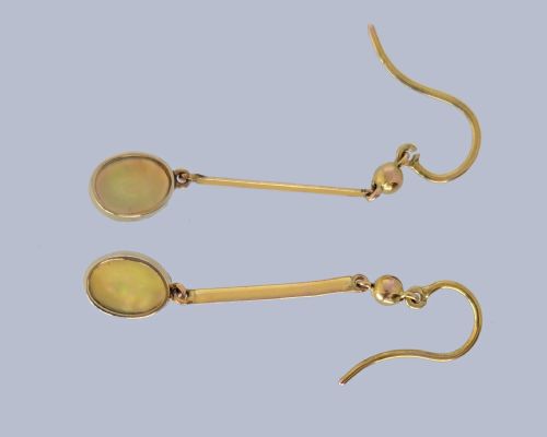 fig 4. A pair of vintage 18 carat yellow gold drop earrings featuring slender vertical bars suspended from wire hooks and terminating in oval opal cabochons displaying blue and green play-of-colour within milgrain settings.