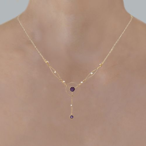 fig 1. An Edwardian 18ct gold lavalier necklace featuring openwork geometric wire loops set with small diamonds, a central round bezel-set amethyst, and a vertical drop terminating in a second amethyst stone.