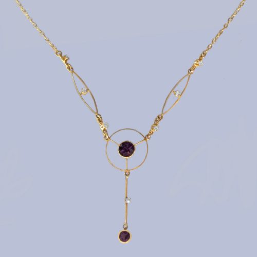 fig 3. An Edwardian 18ct gold lavalier necklace featuring openwork geometric wire loops set with small diamonds, a central round bezel-set amethyst, and a vertical drop terminating in a second amethyst stone.