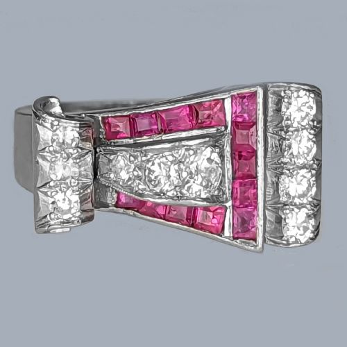 fig 2. A platinum Art Deco buckle ring featuring channel-set red rubies and pave-set old cut diamonds forming a curved scroll motif.