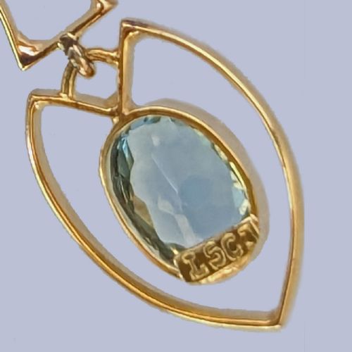 fig 8. An Edwardian 15ct yellow gold drop pendant featuring a round aquamarine stone above an openwork heart-shaped frame housing an oval aquamarine gemstone on a fine link chain.
