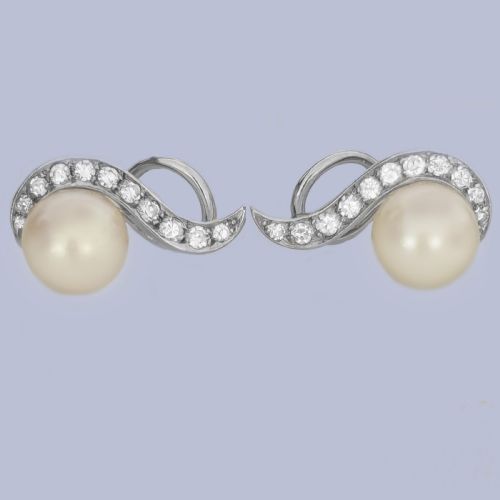 fig 3. A pair of 18ct white gold stud earrings featuring round cream pearls accented with sweeping bands of grain-set diamonds.