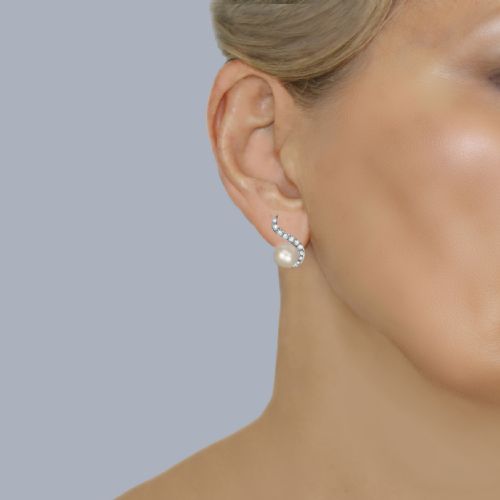 fig 4. A pair of 18ct white gold stud earrings featuring round cream pearls accented with sweeping bands of grain-set diamonds.