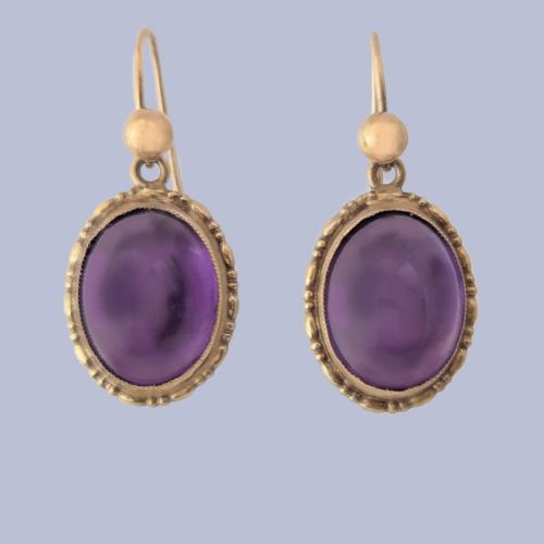 fig 1. Pair of vintage 9ct gold drop earrings featuring oval cabochon purple amethysts set in decorative gold borders with shepherds hook wires.