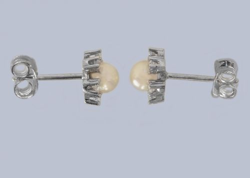 fig 2. A pair of 18ct white gold stud earrings featuring a central cream pearl surrounded by six claw-set diamonds in a floral cluster arrangement.