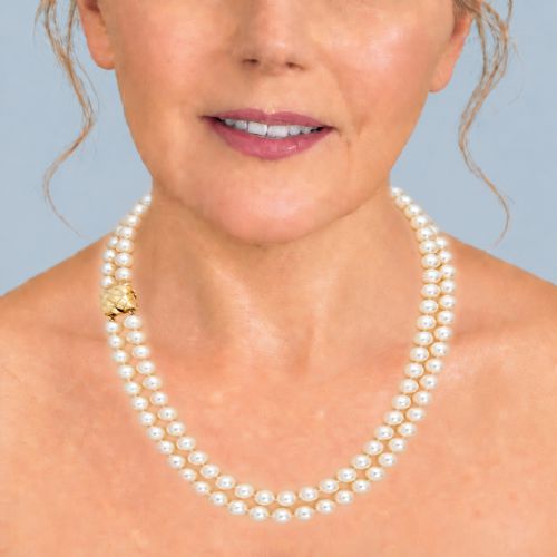 fig 1. A double strand cultured pearl necklace featuring a square textured gold clasp embellished with diamonds.