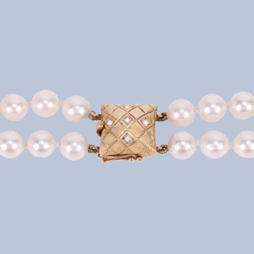 fig 2. A double strand cultured pearl necklace featuring a square textured gold clasp embellished with diamonds.