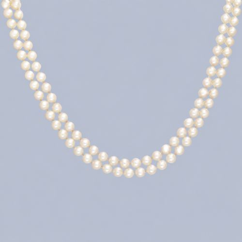 fig 4. A double strand cultured pearl necklace featuring a square textured gold clasp embellished with diamonds.