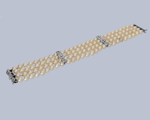 fig 1. A vintage four-strand cultured pearl bracelet connected by three white gold bow-shaped spacers set with small diamonds.