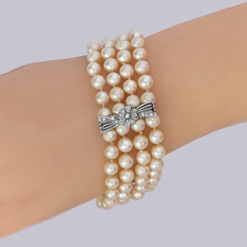 fig 2. A vintage four-strand cultured pearl bracelet connected by three white gold bow-shaped spacers set with small diamonds.
