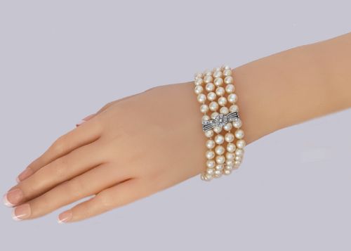 fig 4. A vintage four-strand cultured pearl bracelet connected by three white gold bow-shaped spacers set with small diamonds.
