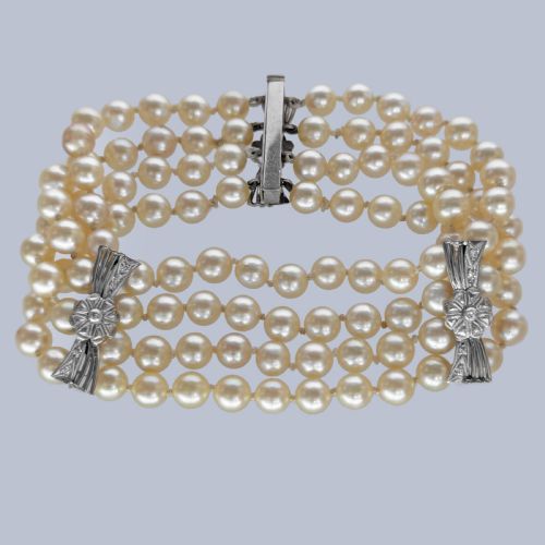 fig 6. A vintage four-strand cultured pearl bracelet connected by three white gold bow-shaped spacers set with small diamonds.