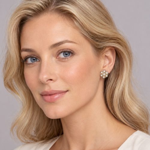 fig 1. A pair of 1960s 18ct gold flowerhead cluster earrings set with central and surrounding cream pearls interspersed with diamond accents.