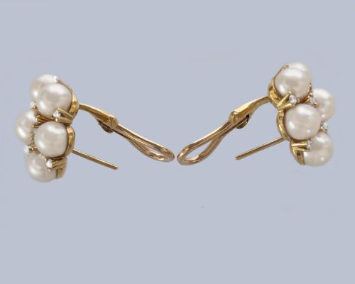 fig 4. A pair of 1960s 18ct gold flowerhead cluster earrings set with central and surrounding cream pearls interspersed with diamond accents.
