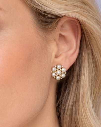 fig 6. A pair of 1960s 18ct gold flowerhead cluster earrings set with central and surrounding cream pearls interspersed with diamond accents.