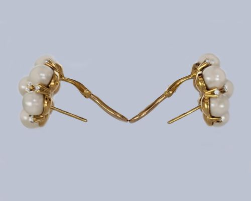 fig 9. A pair of 1960s 18ct gold flowerhead cluster earrings set with central and surrounding cream pearls interspersed with diamond accents.