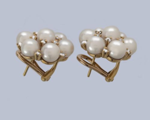 fig 10. A pair of 1960s 18ct gold flowerhead cluster earrings set with central and surrounding cream pearls interspersed with diamond accents.