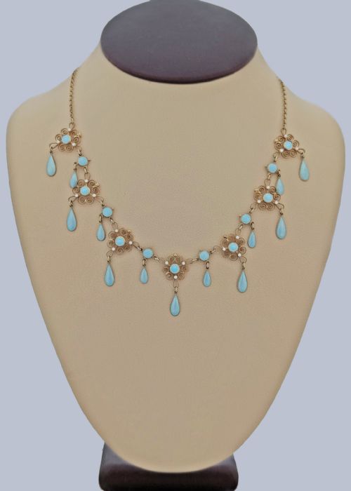 fig 10. An Art Nouveau silver gilt festoon necklace featuring filigree scrollwork, turquoise guilloche enamel discs, and suspended teardrop pendants.