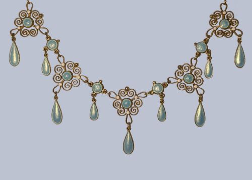 fig 11. An Art Nouveau silver gilt festoon necklace featuring filigree scrollwork, turquoise guilloche enamel discs, and suspended teardrop pendants.