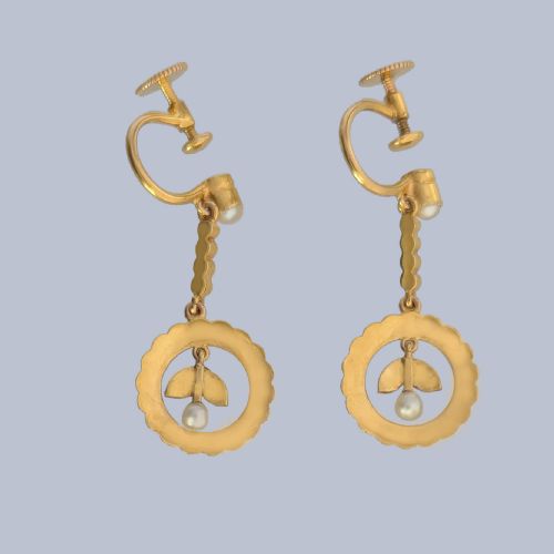 fig 3. A pair of Edwardian 15ct yellow gold drop earrings featuring circular seed pearl frames around foliate central motifs with screw-back fittings.