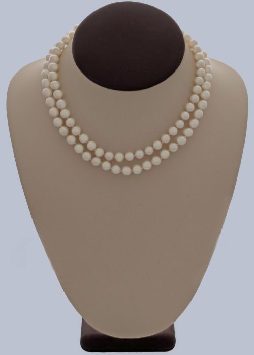 fig 8. A long single strand of creamy white cultured pearls featuring a 9ct gold flower cluster clasp set with a central purple amethyst.