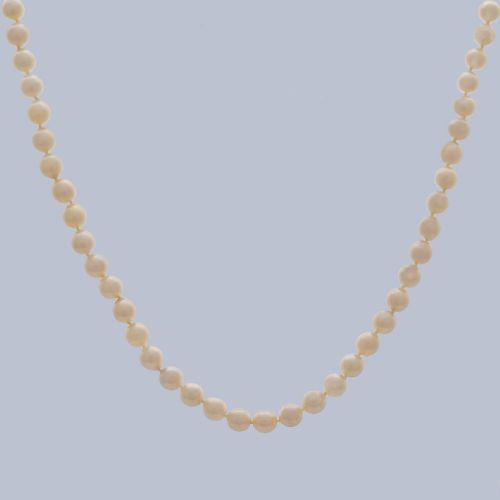 fig 9. A long single strand of creamy white cultured pearls featuring a 9ct gold flower cluster clasp set with a central purple amethyst.