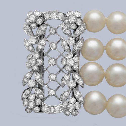 fig 2. An Edwardian four-strand pearl bracelet featuring a central openwork diamond floral clasp in white metal.