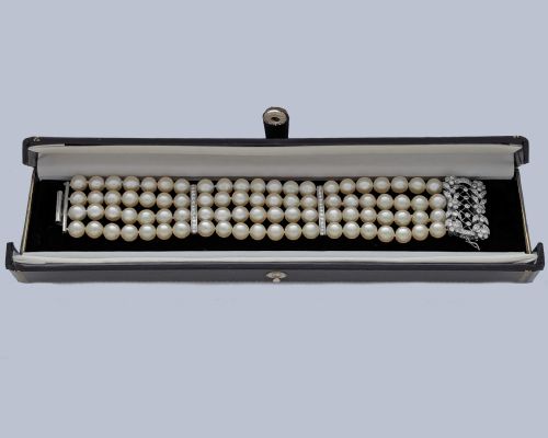 fig 8. An Edwardian four-strand pearl bracelet featuring a central openwork diamond floral clasp in white metal.