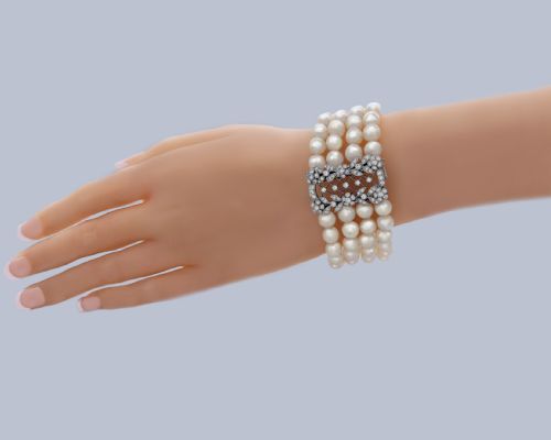 fig 9. An Edwardian four-strand pearl bracelet featuring a central openwork diamond floral clasp in white metal.