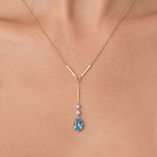 fig 1. An Edwardian 15ct yellow gold lavalier pendant necklace featuring a geometric bar drop, two millegrain-set old cut diamonds, and an oval blue topaz gemstone.