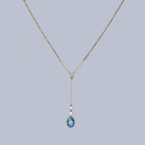 fig 2. An Edwardian 15ct yellow gold lavalier pendant necklace featuring a geometric bar drop, two millegrain-set old cut diamonds, and an oval blue topaz gemstone.