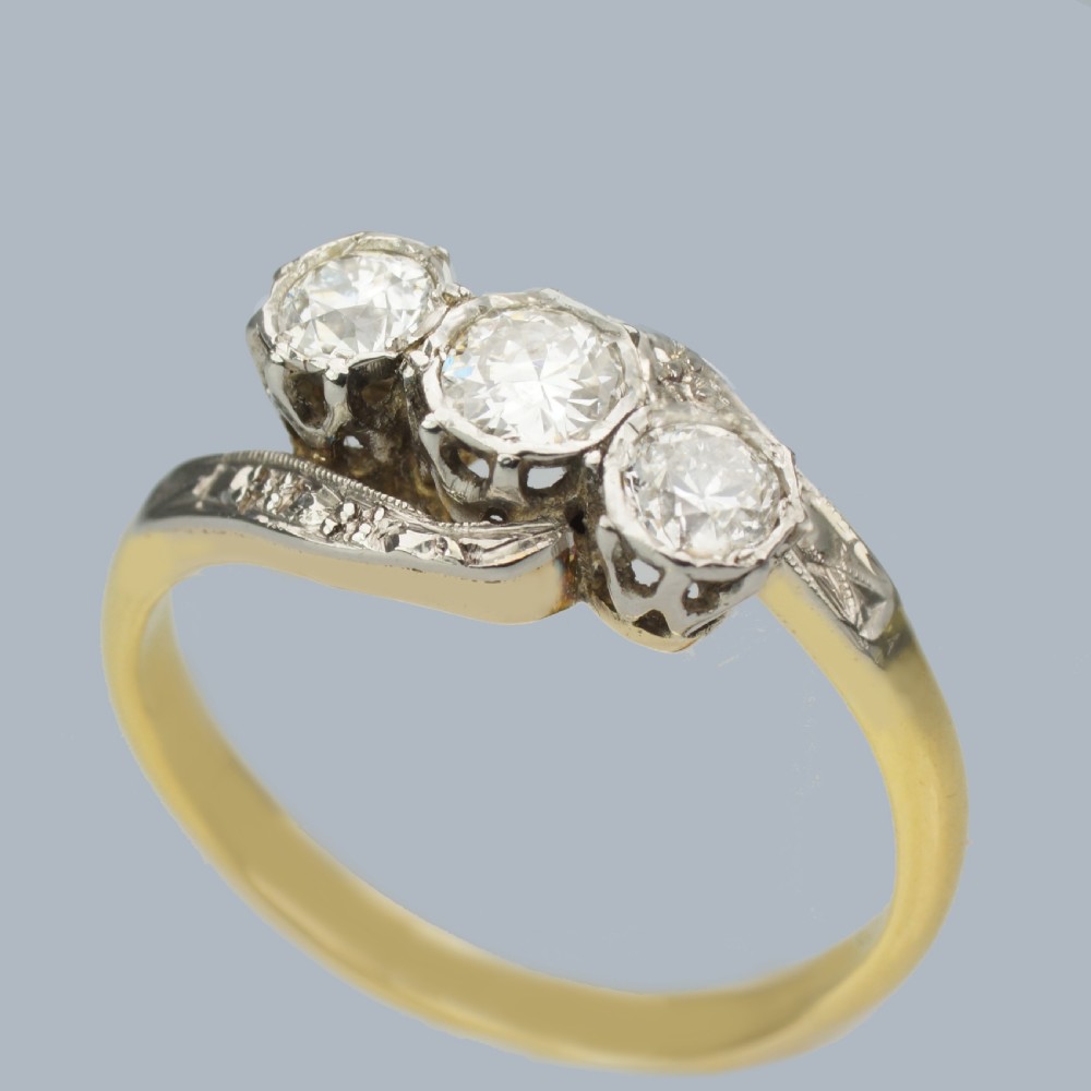 An Edwardian 18ct yellow gold trilogy ring with three round diamonds set diagonally in a platinum twist setting. View II