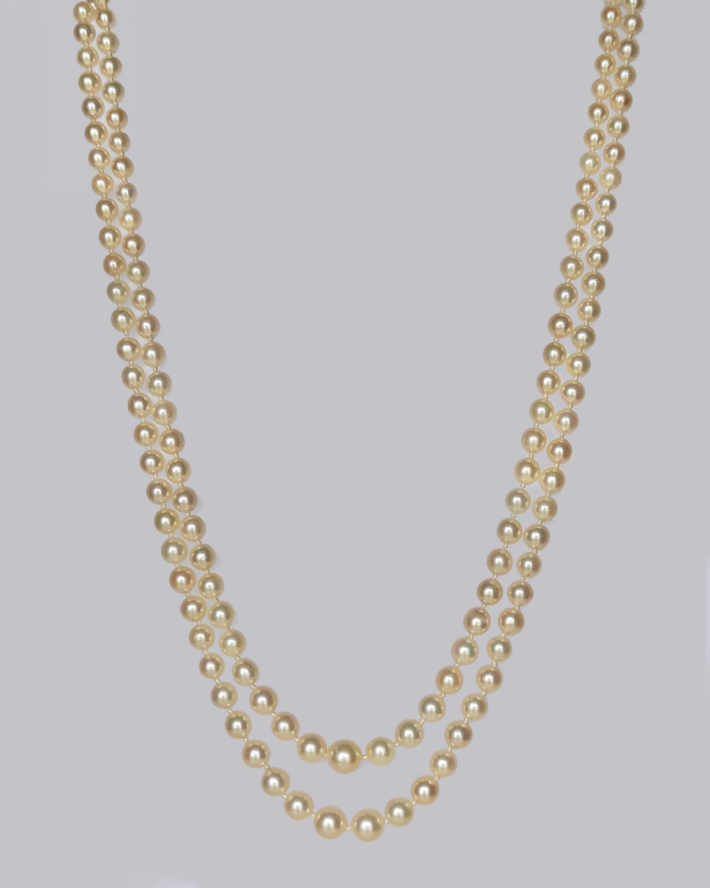 A double strand vintage pearl necklace featuring cream pearls and a circular floral 9ct gold clasp set with pearls and blue sapphires. View III