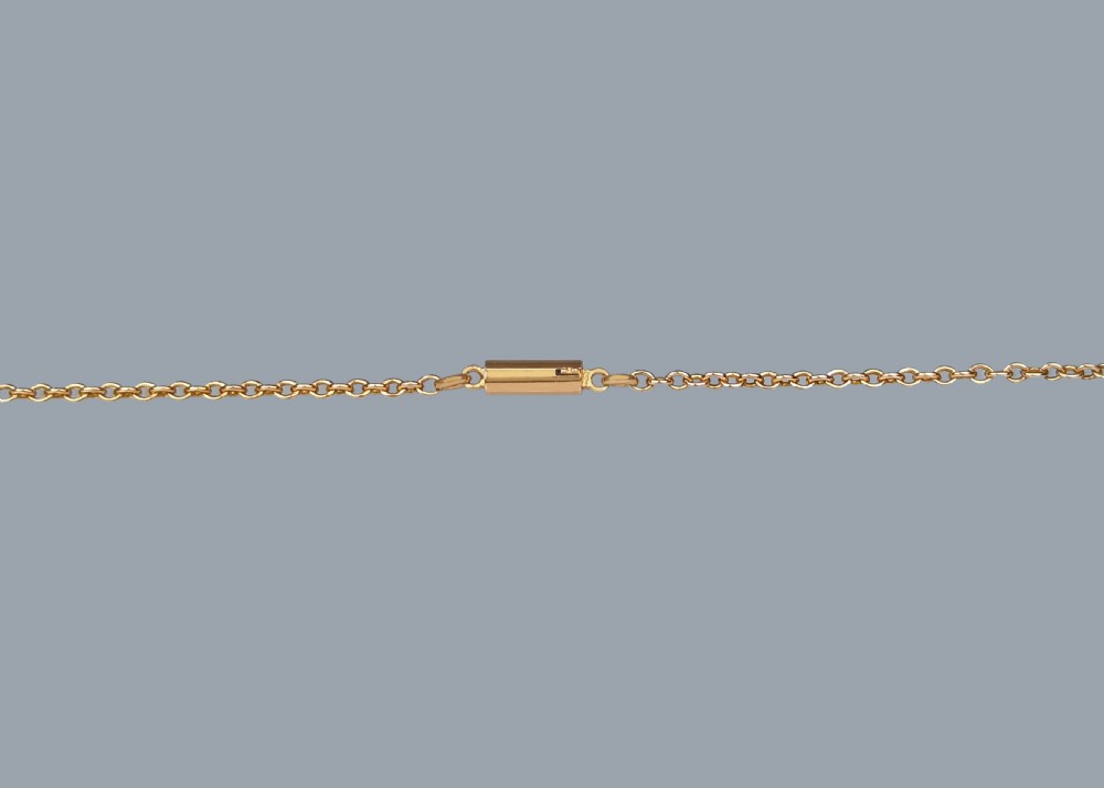 An Edwardian 15ct gold chain displaying a circular openwork garland pendant set with a central round green peridot surrounded by seed pearl leaves and a single pearl drop. View V