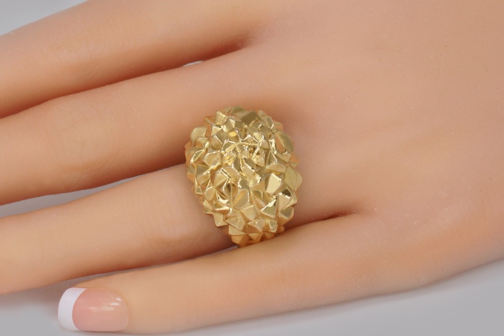 A heavy 18ct yellow gold bombe ring featuring a faceted geometric textured surface with an adjustable inner band. View II