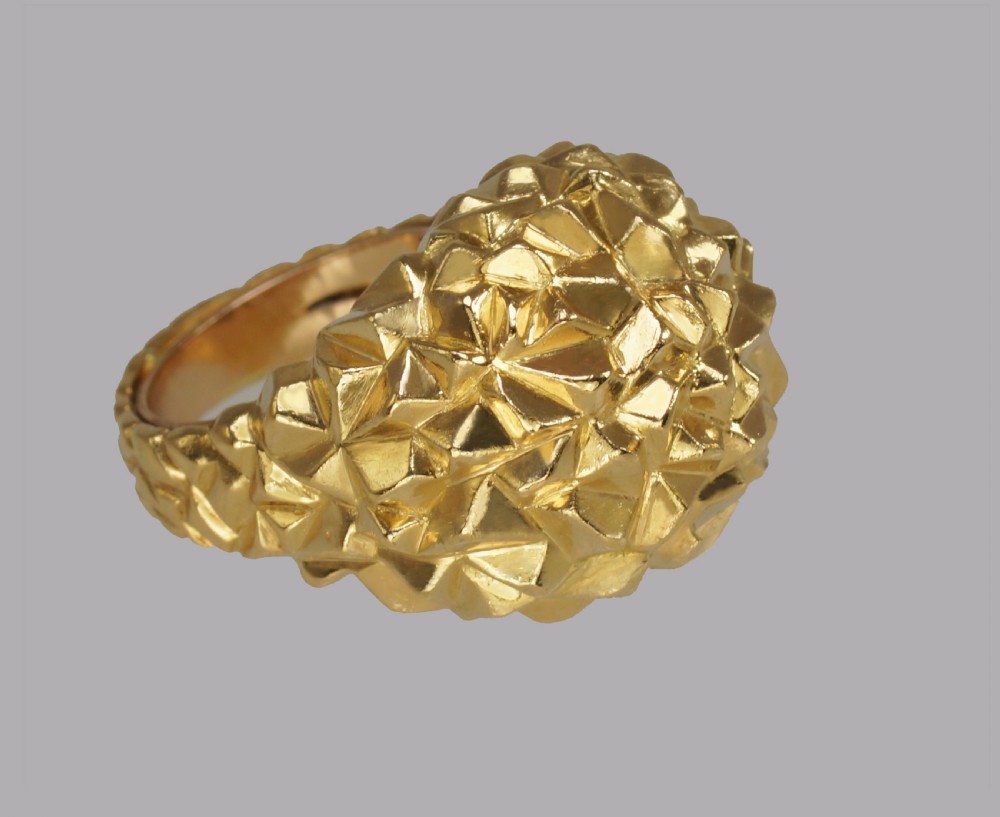 A heavy 18ct yellow gold bombe ring featuring a faceted geometric textured surface with an adjustable inner band. View III