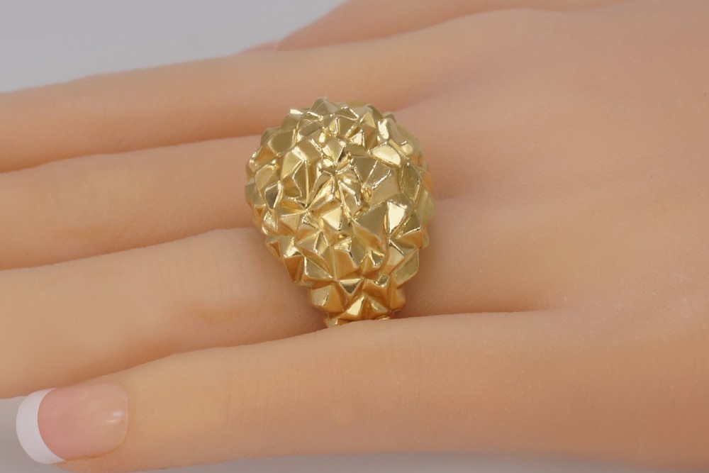 A heavy 18ct yellow gold bombe ring featuring a faceted geometric textured surface with an adjustable inner band. View IV