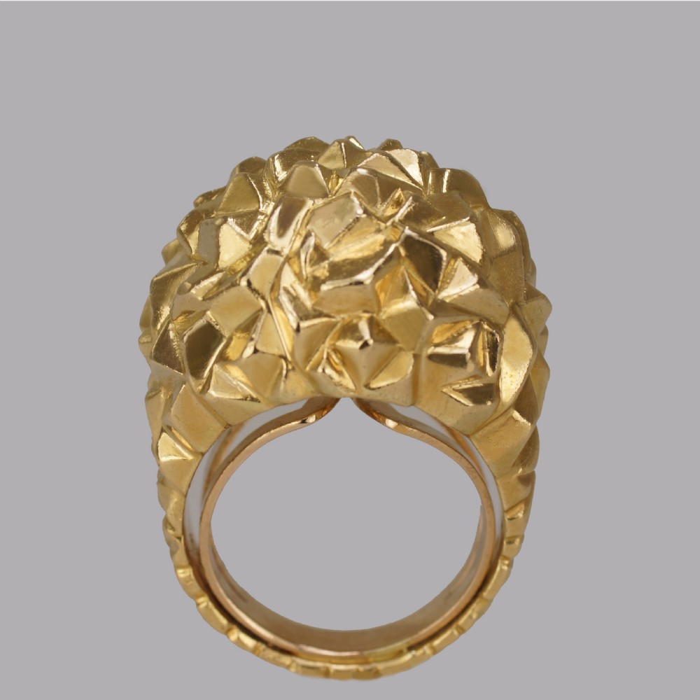 A heavy 18ct yellow gold bombe ring featuring a faceted geometric textured surface with an adjustable inner band. View V