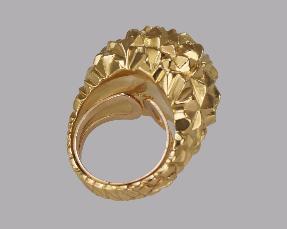 A heavy 18ct yellow gold bombe ring featuring a faceted geometric textured surface with an adjustable inner band. View VI