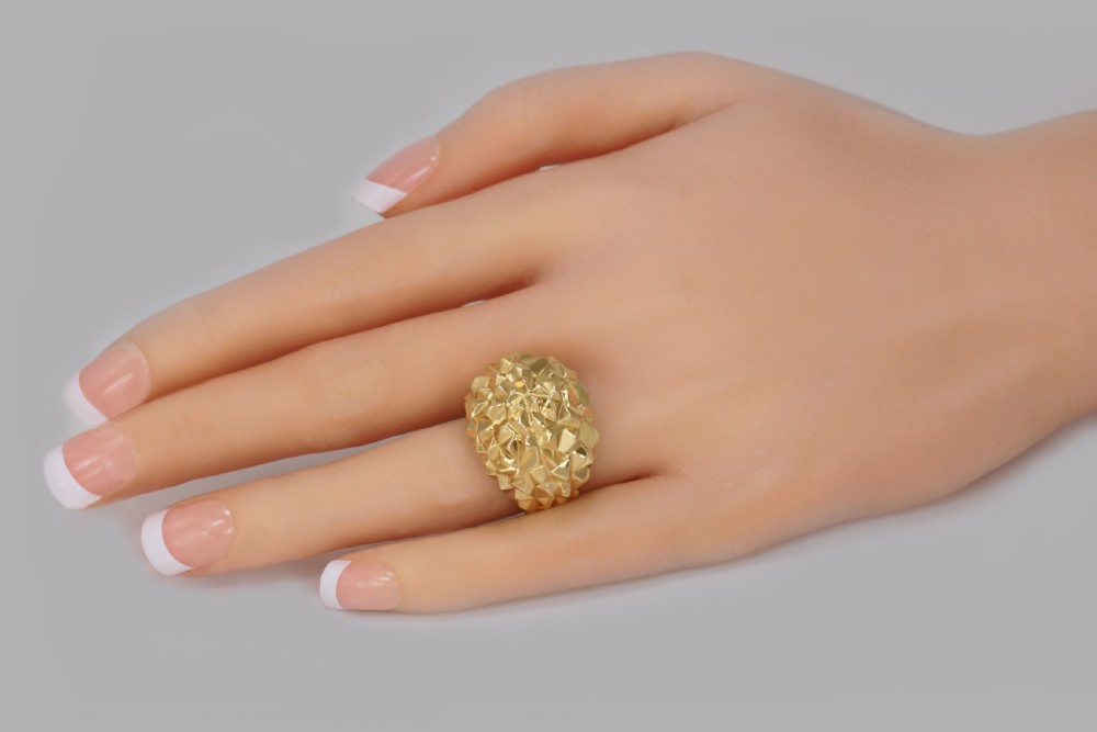 A heavy 18ct yellow gold bombe ring featuring a faceted geometric textured surface with an adjustable inner band. View IX