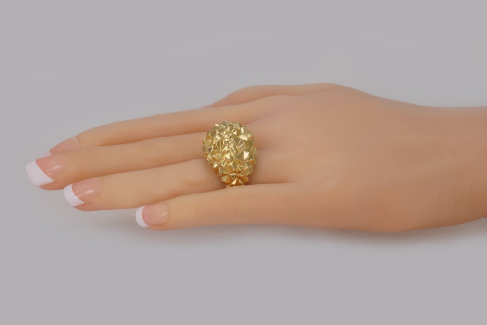A heavy 18ct yellow gold bombe ring featuring a faceted geometric textured surface with an adjustable inner band. View X