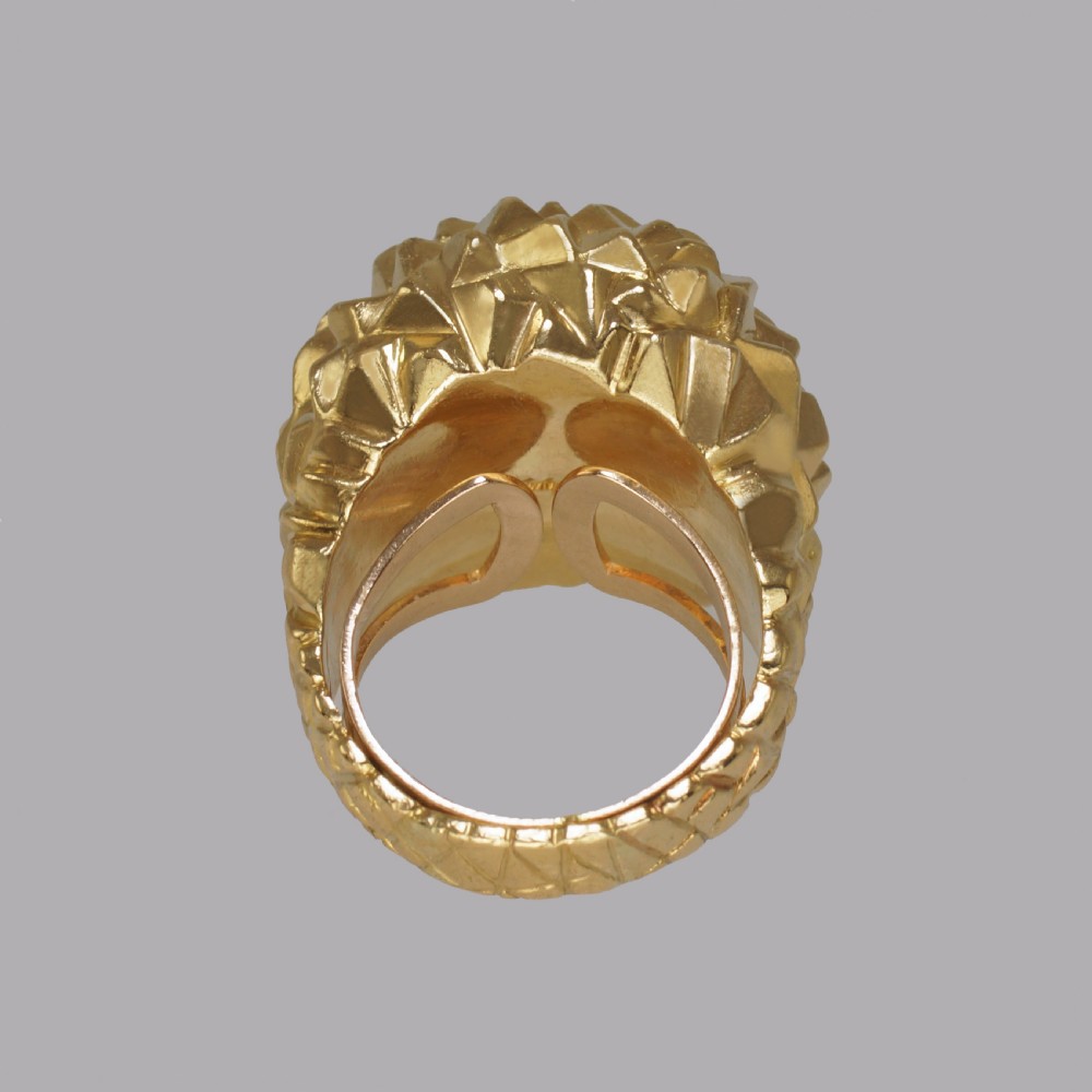 A heavy 18ct yellow gold bombe ring featuring a faceted geometric textured surface with an adjustable inner band. View XI