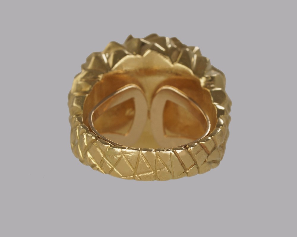 A heavy 18ct yellow gold bombe ring featuring a faceted geometric textured surface with an adjustable inner band. View XII
