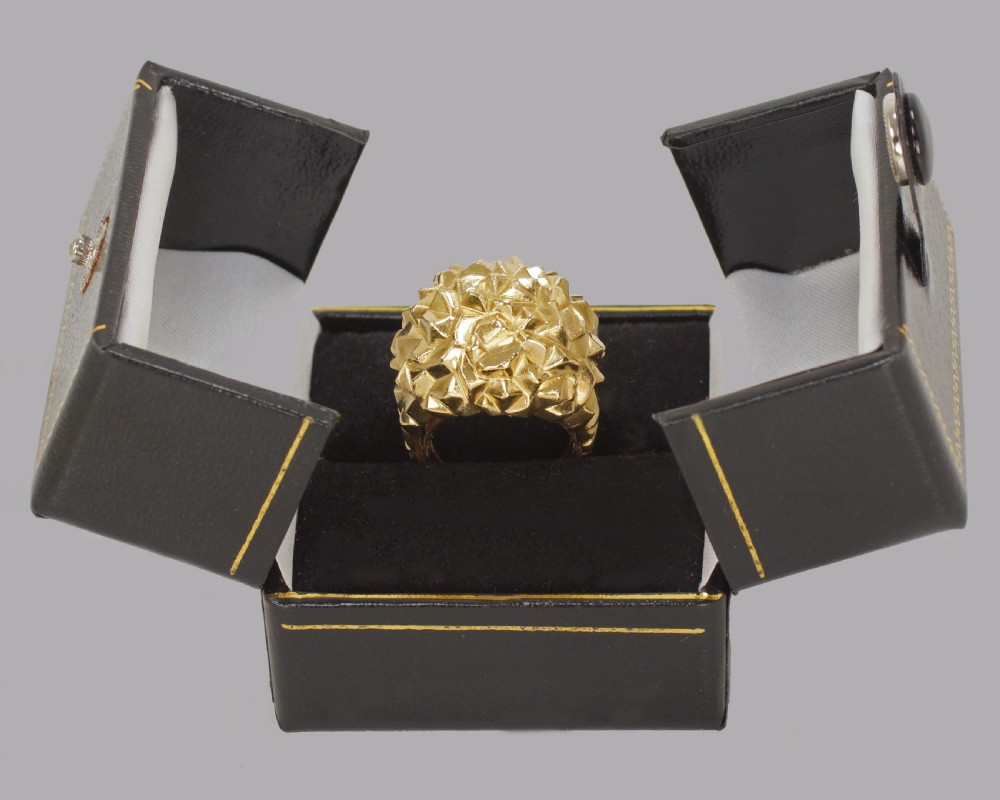 A heavy 18ct yellow gold bombe ring featuring a faceted geometric textured surface with an adjustable inner band. View XIV
