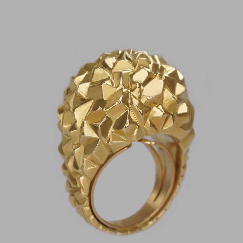A heavy 18ct yellow gold bombe ring featuring a faceted geometric textured surface with an adjustable inner band. View XV