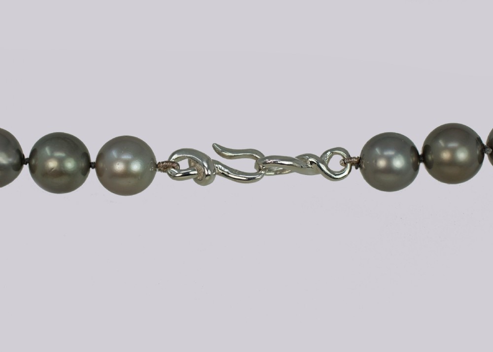 A single strand of lustrous charcoal grey Tahitian cultured pearls featuring an 18ct white gold clasp. View VI