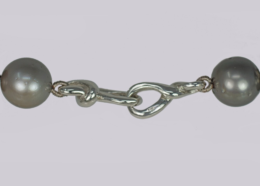 A single strand of lustrous charcoal grey Tahitian cultured pearls featuring an 18ct white gold clasp. View VII