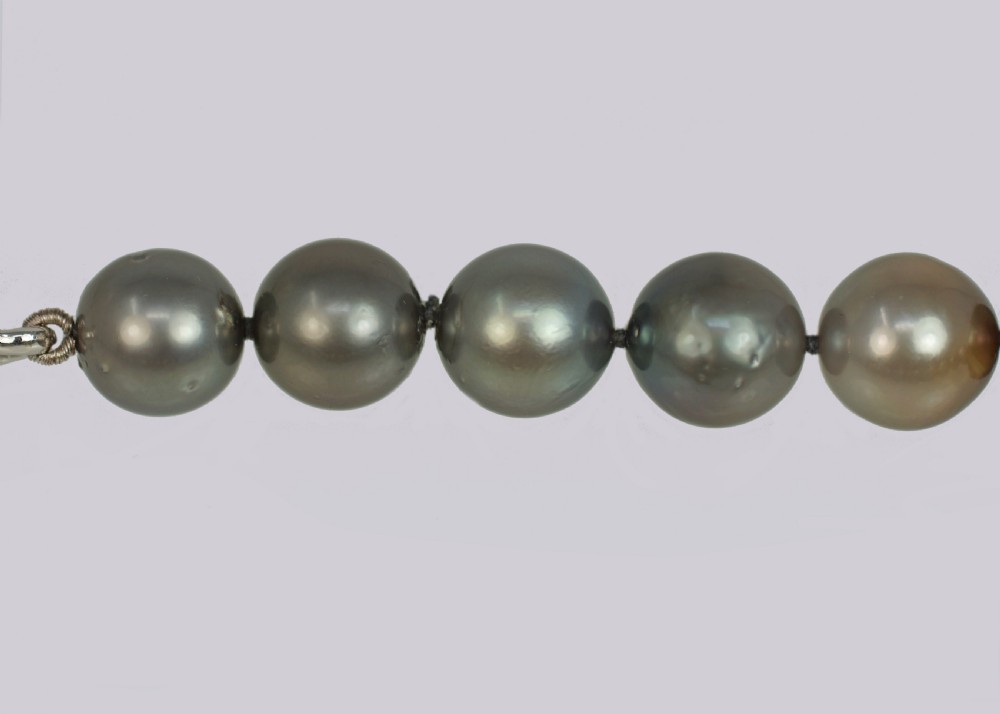 A single strand of lustrous charcoal grey Tahitian cultured pearls featuring an 18ct white gold clasp. View VIII