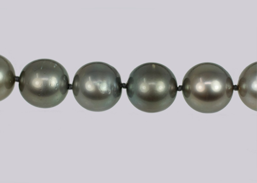 A single strand of lustrous charcoal grey Tahitian cultured pearls featuring an 18ct white gold clasp. View IX