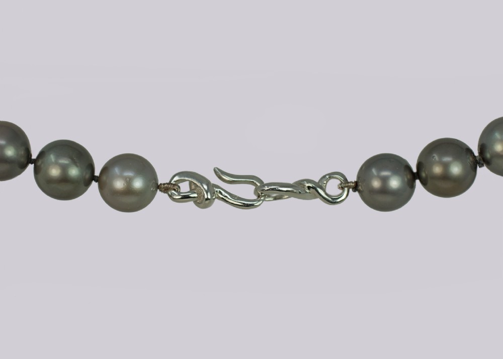 A single strand of lustrous charcoal grey Tahitian cultured pearls featuring an 18ct white gold clasp. View XIII